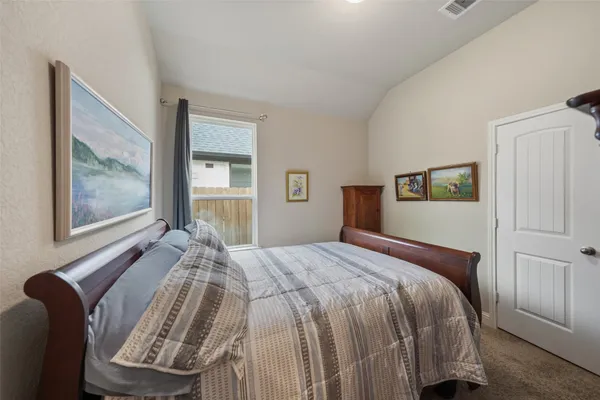 a bed sitting in a bedroom next to a window