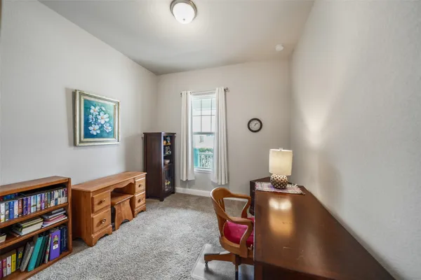 a living room with furniture and a bookshelf
