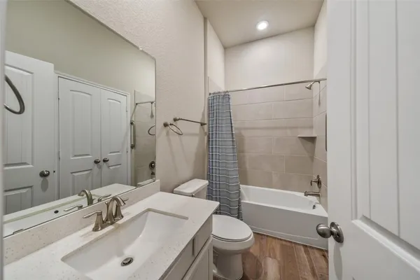 a bathroom with a sink toilet and shower