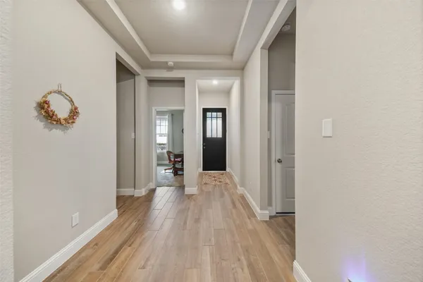 a view of a hallway with wooden floor