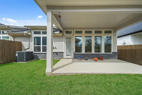 a view of a house with backyard and porch