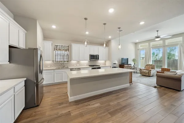 a large kitchen with stainless steel appliances lots of counter top space