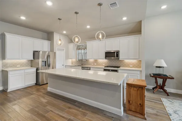 a kitchen with a sink stainless steel appliances and cabinets