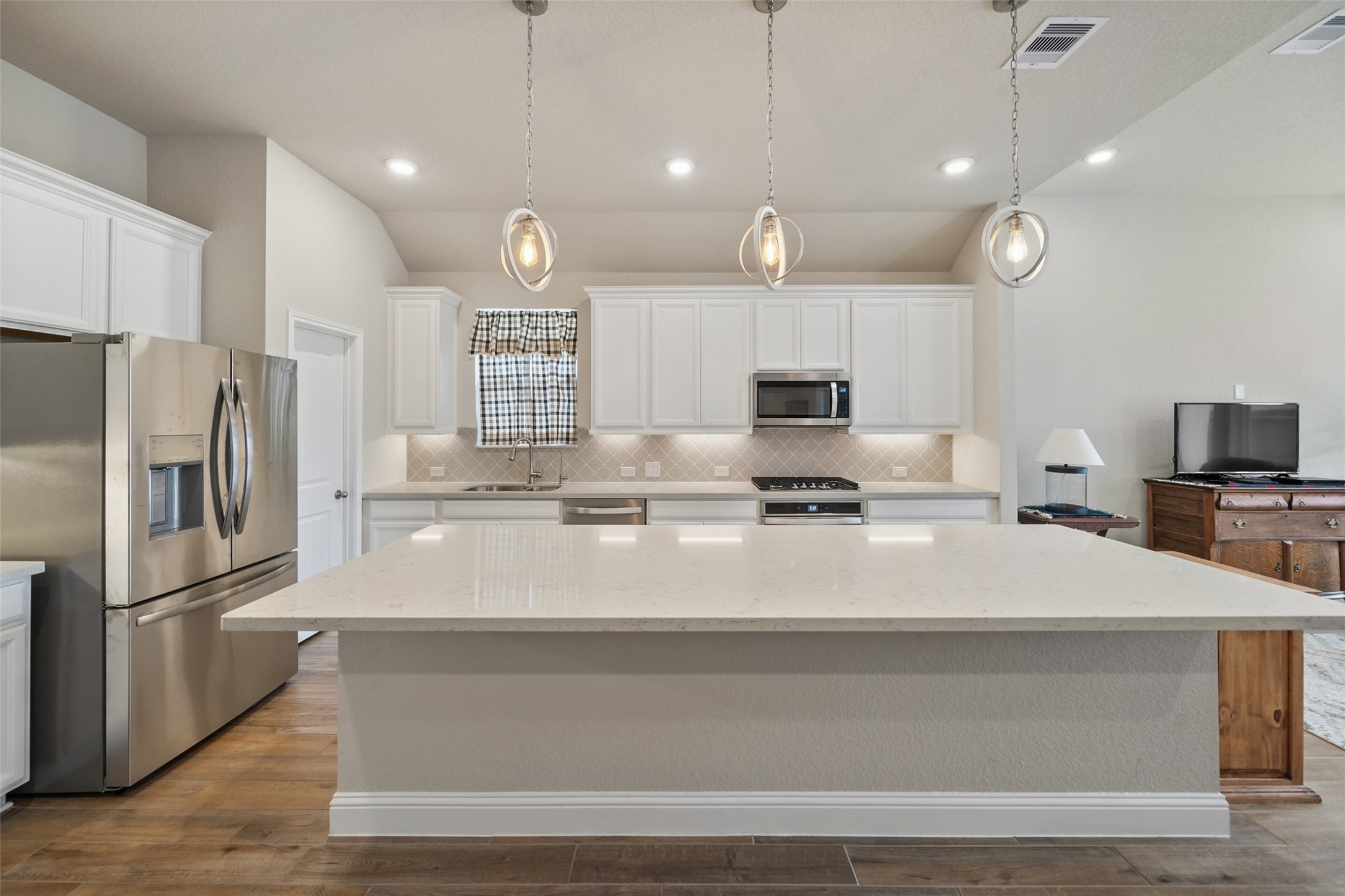 21335 Sierra Point Lane Porter, TX 77365 - Photo 5 of 33 a large kitchen with stainless steel appliances a large counter top oven and cabinets