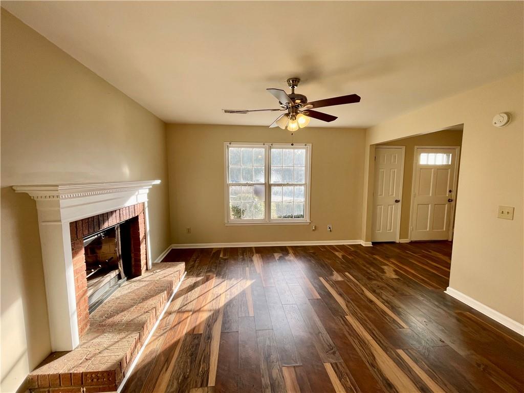 256 Robbie Lane Marietta, GA 30060 - Photo 4 of 17 a view of an empty room with wooden floor fireplace and a window