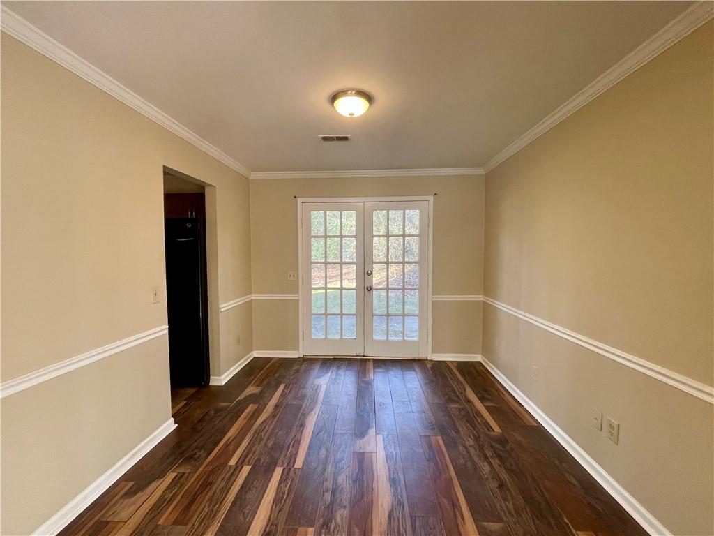 256 Robbie Lane Marietta, GA 30060 - Photo 6 of 17 a view of an empty room with wooden floor and a window