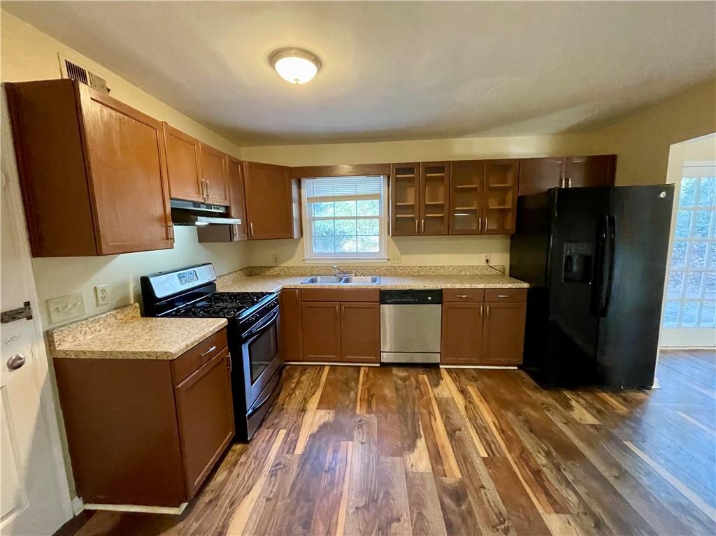 256 Robbie Lane Marietta, GA 30060 - Photo 9 of 17 a kitchen with a sink a counter top space stainless steel appliances and a window