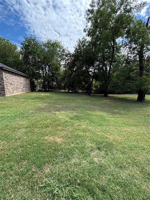 343 North Morris Street Gainesville, TX 76240 - Photo 17 of 18 a view of a field with trees in the background