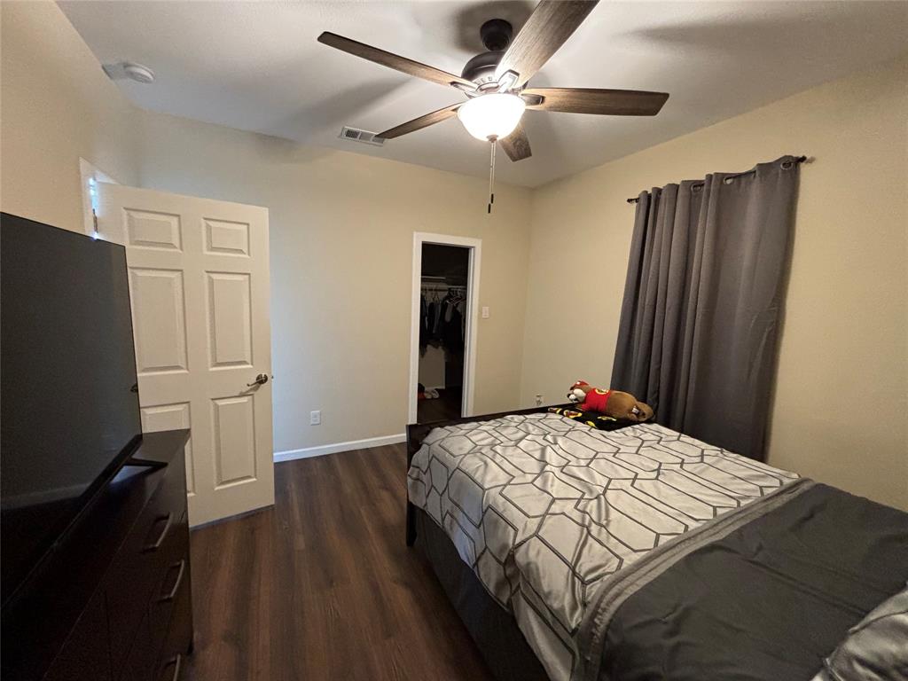 343 North Morris Street Gainesville, TX 76240 - Photo 9 of 18 a bedroom with a bed and a flat screen tv