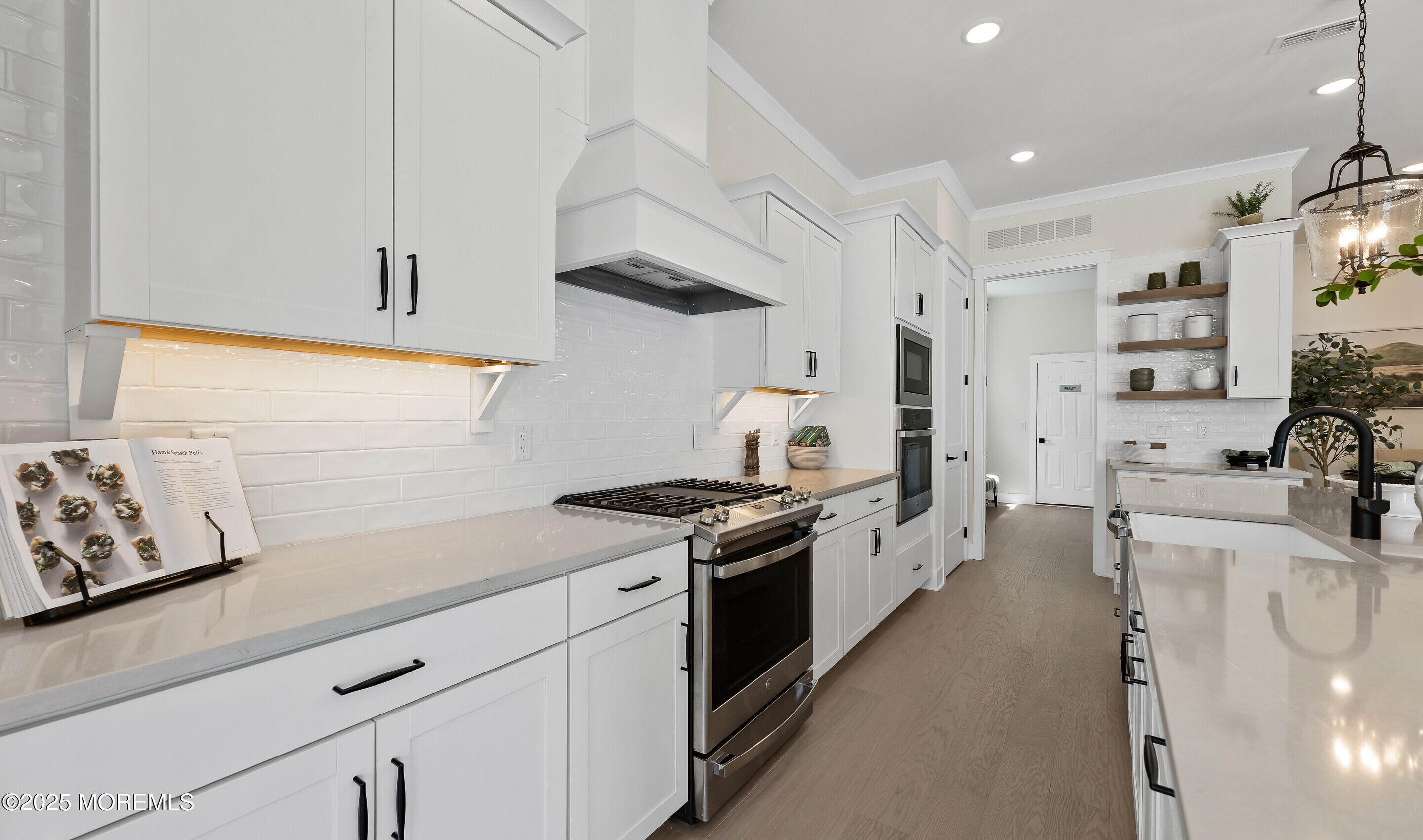 176 Highway 33, Unit IBIZA II LOFT Manalapan, NJ 07726 - Photo 34 of 39 a kitchen with stainless steel appliances granite countertop a sink stove and refrigerator