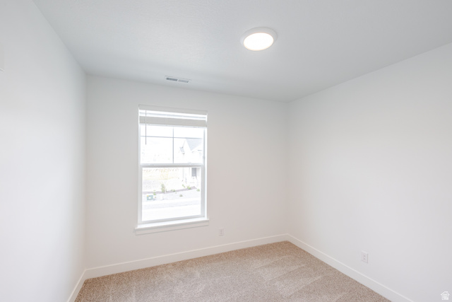 675 West 4500th South, Unit P302 Mapleton, UT 84664 - Photo 5 of 16 Bright room featuring a single window, recessed lighting, neutral carpet flooring, and white baseboards