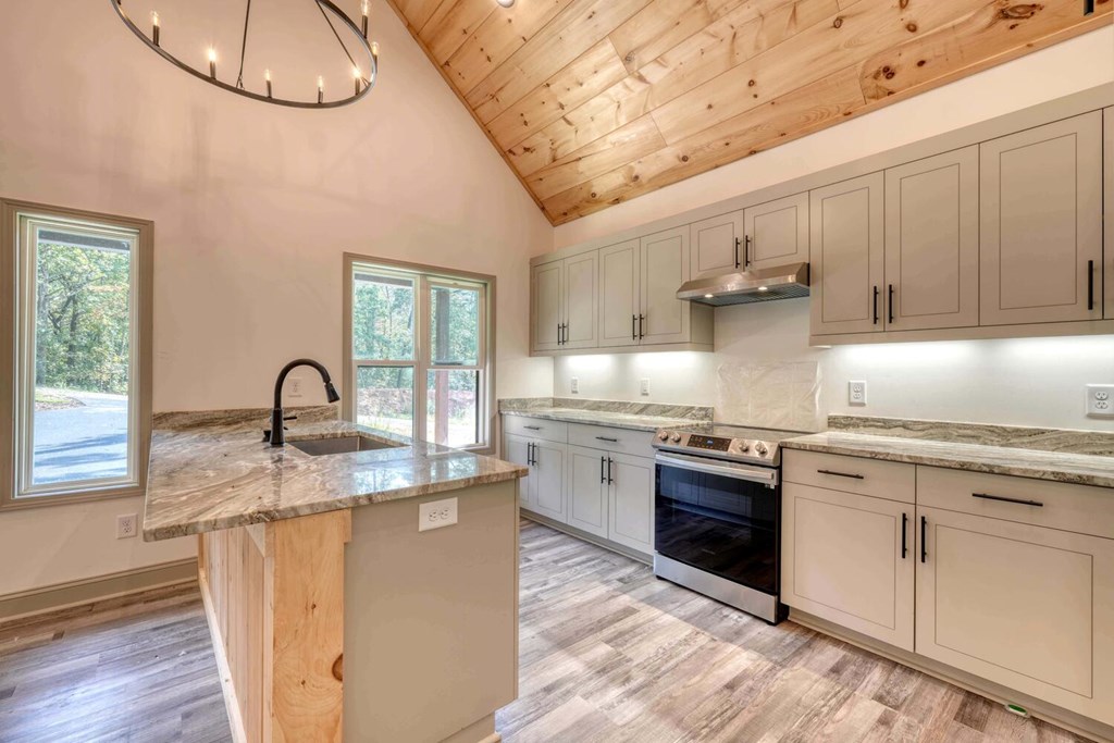 63 Nottaway Road Young Harris, GA 30582 - Photo 15 of 35 a kitchen with stainless steel appliances granite countertop a stove a sink and a microwave