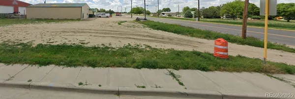 a view of a yard with potted plants