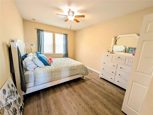 a bedroom with a bed dresser and a window