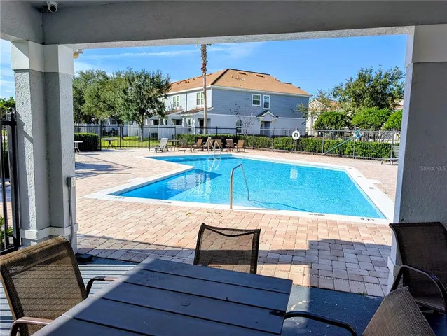 swimming pool view with a seating space