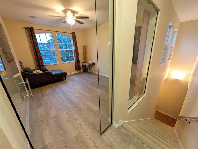 a view of a livingroom with wooden floor and staircase
