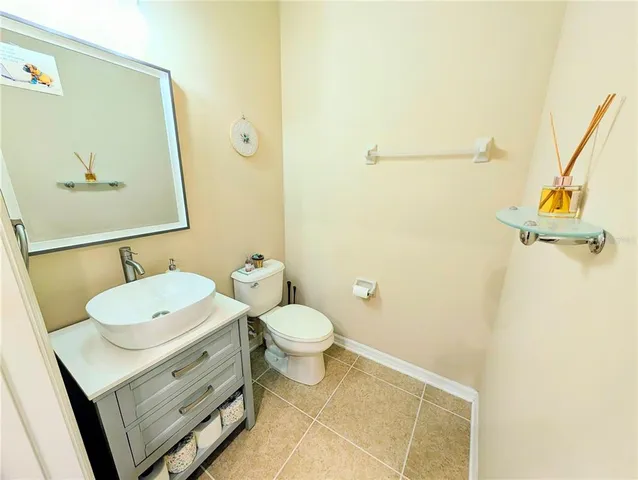 a bathroom with a toilet sink and a mirror
