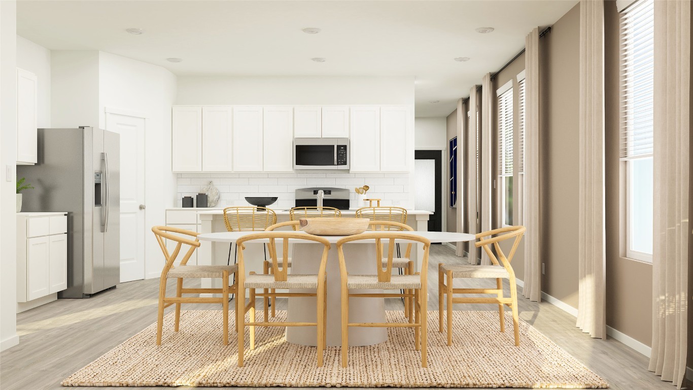 23405 Firelight Drive Elgin, TX 78621 - Photo 12 of 33 a kitchen with stainless steel appliances granite countertop a dining table chairs refrigerator and a window