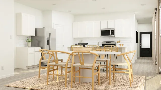 a dining room with furniture and a kitchen view