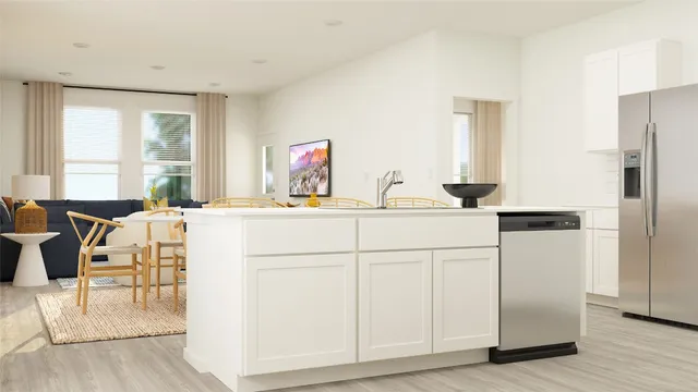 a kitchen with white cabinets and sink