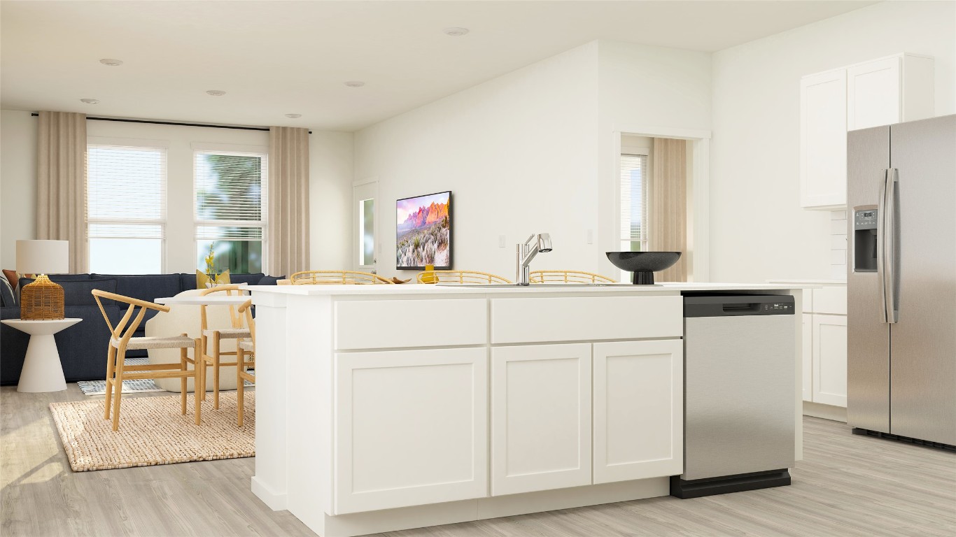 23405 Firelight Drive Elgin, TX 78621 - Photo 21 of 33 a kitchen with white cabinets and sink