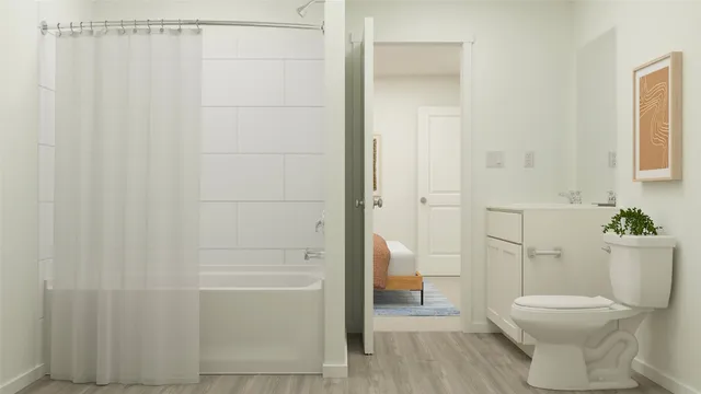 a bathroom with a toilet and a shower