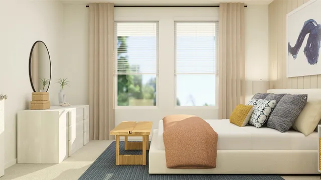 a bed sitting in a bedroom next to a window