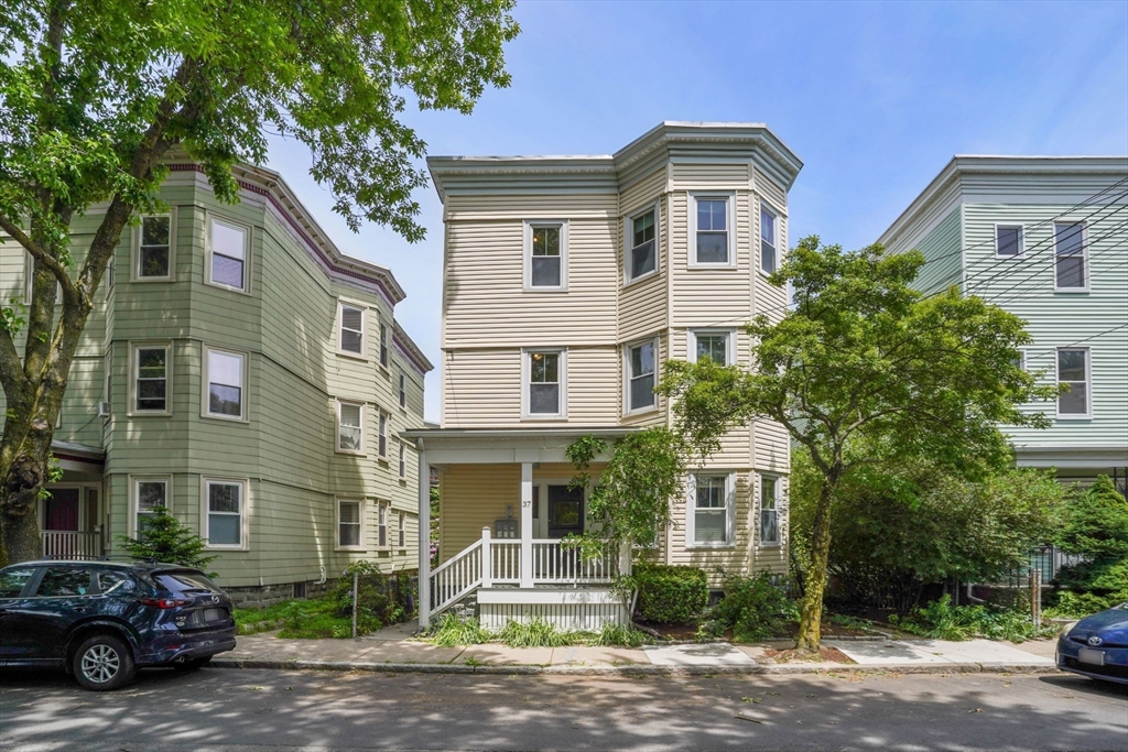37 Dimick Street, Unit 3 Somerville, MA 02143 - Photo 11 of 12 a front view of a house with a yard