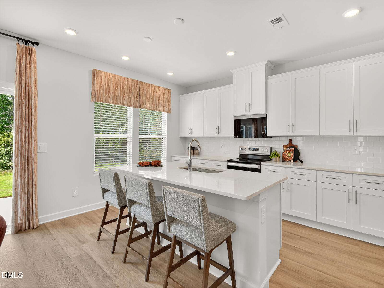 62 Thistle Patch Place Angier, NC 27501 - Photo 4 of 22 a kitchen with a dining table chairs and refrigerator
