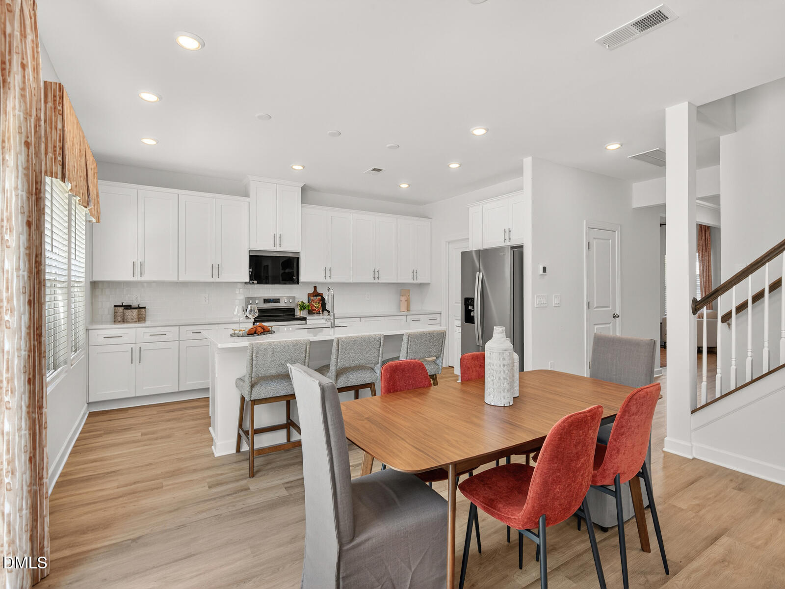 62 Thistle Patch Place Angier, NC 27501 - Photo 6 of 22 a kitchen with stainless steel appliances granite countertop a dining table chairs refrigerator and microwave