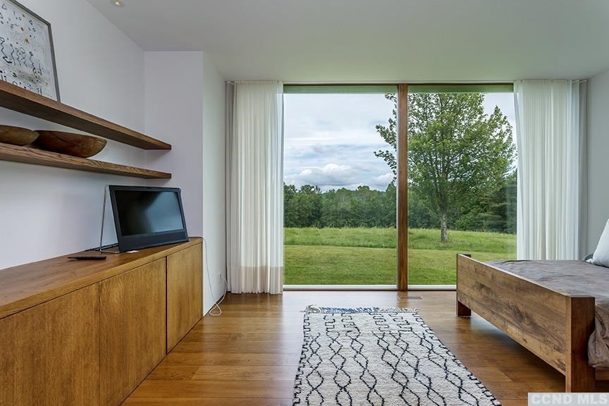 708 New Forge Rd II Taghkanic, NY 12502 - Photo 11 of 29 a view of a two room with wooden floor and a bed