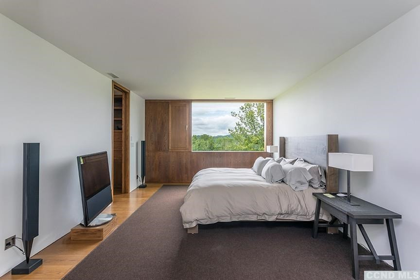 708 New Forge Rd II Taghkanic, NY 12502 - Photo 14 of 29 a bedroom with a bed and a lamp next to a window