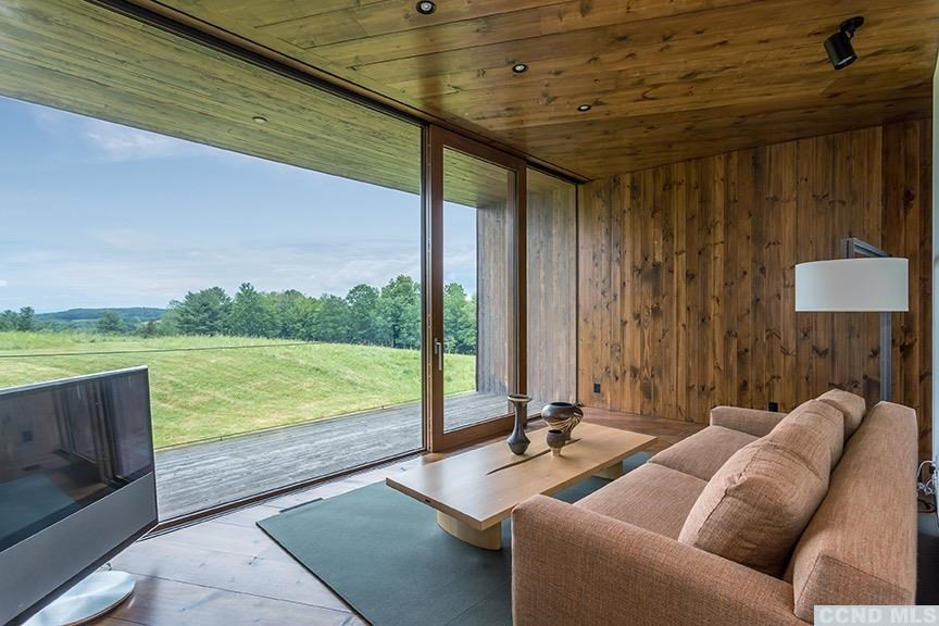 708 New Forge Rd II Taghkanic, NY 12502 - Photo 21 of 29 a balcony with furniture and a floor to ceiling window