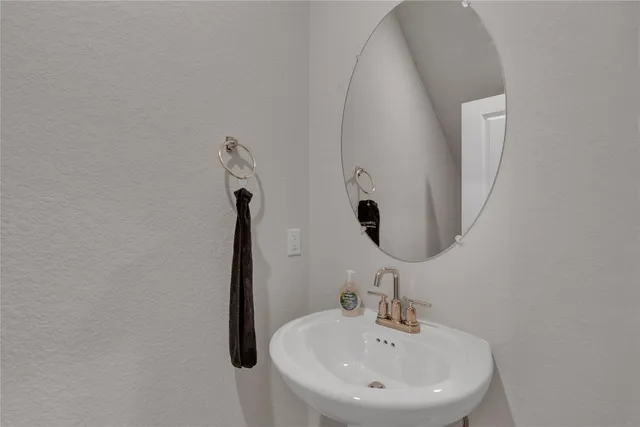 a living room with furniture kitchen view and a chandelier