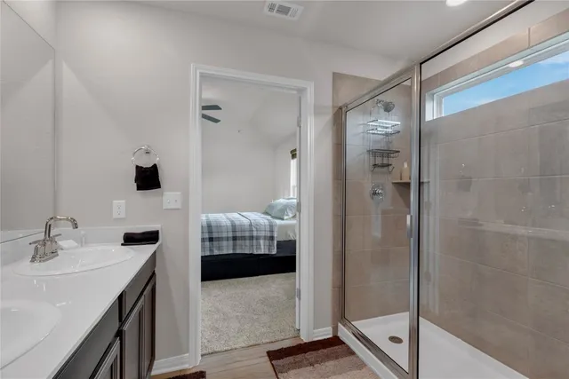 a bathroom with double sink and two mirror