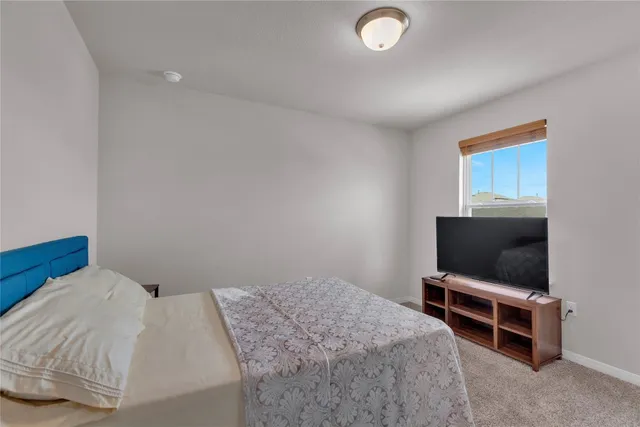 a bedroom with a bed and cabinets