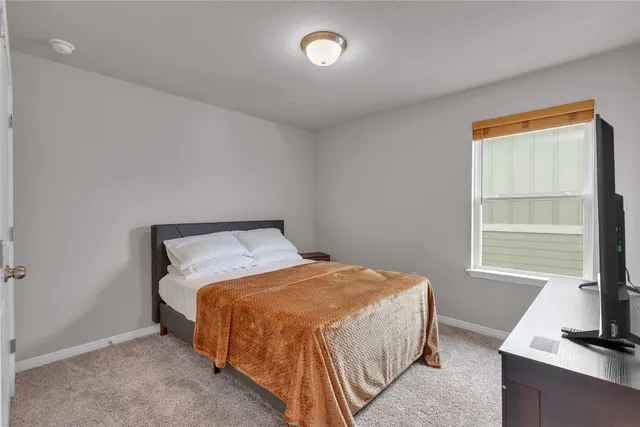 a bedroom with a bed and a dresser