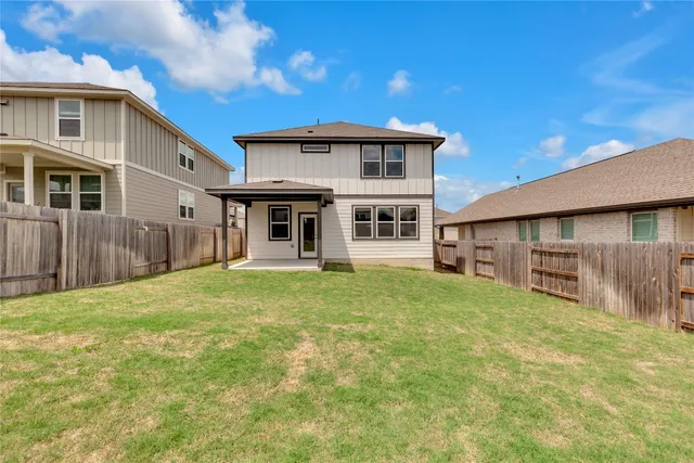 a view of a house with a yard and table
