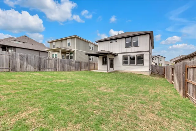 a view of a house with a yard and sitting area