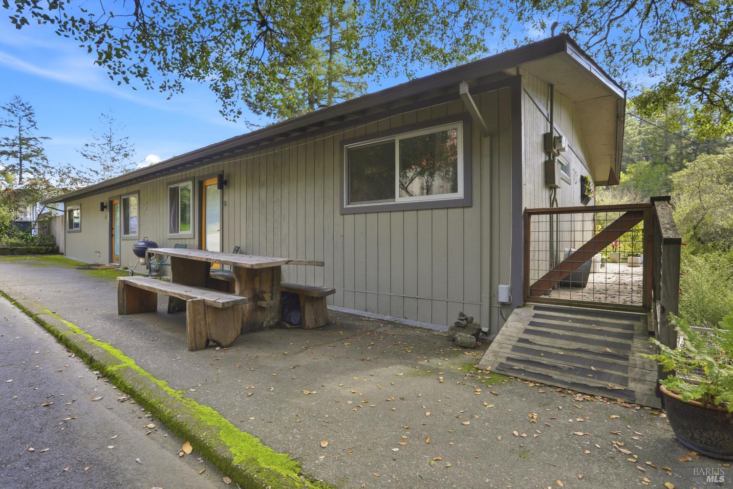 10 Pedrini Way Lagunitas, CA 94938 - Photo 2 of 31 a view of a patio with table and chairs with wooden fence and plants