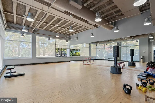a kitchen with a table chairs and refrigerator
