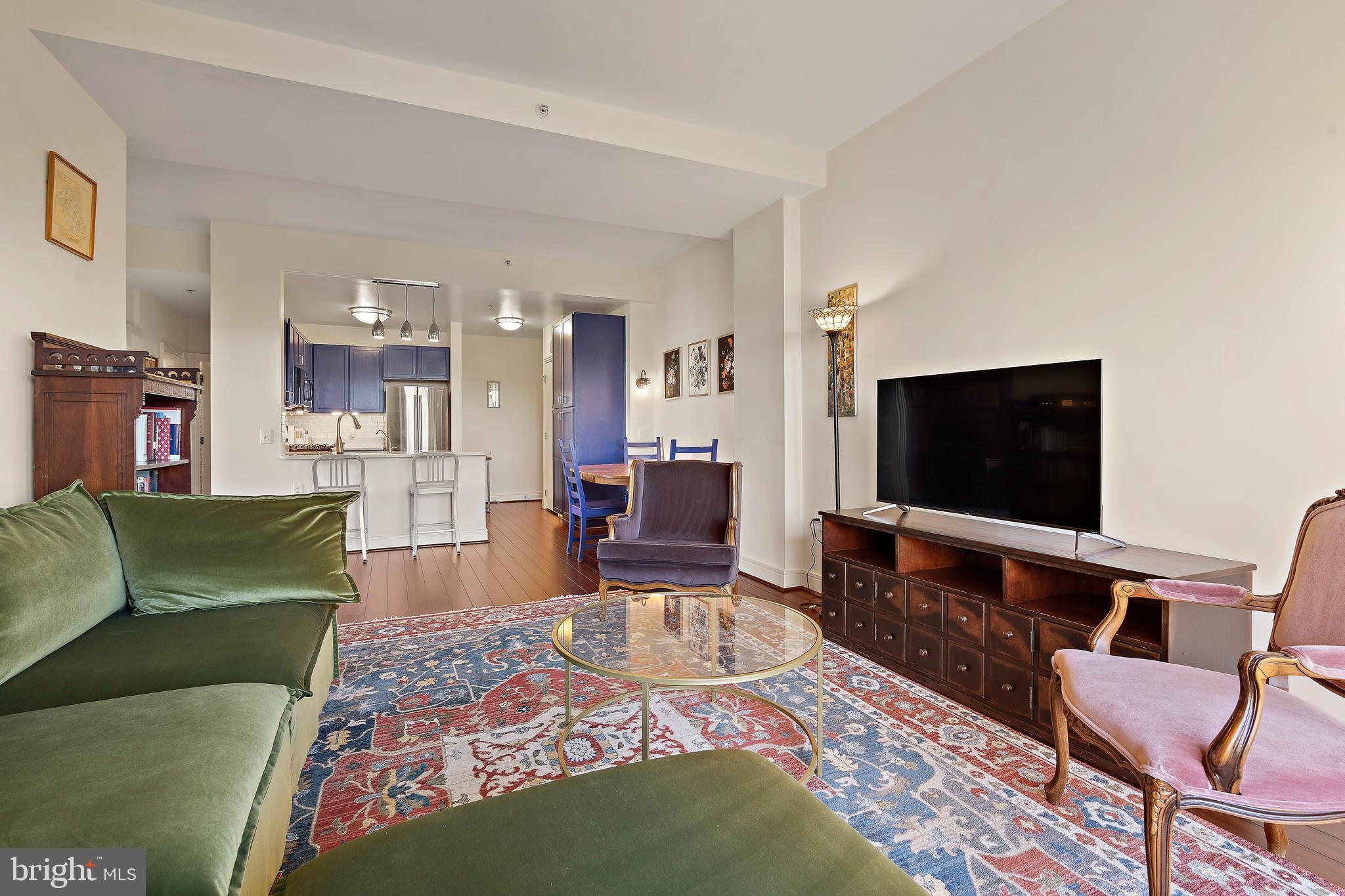 800 4th Street Southwest, Unit N801 Washington, DC 20024 - Photo 2 of 31 a living room with furniture and a flat screen tv