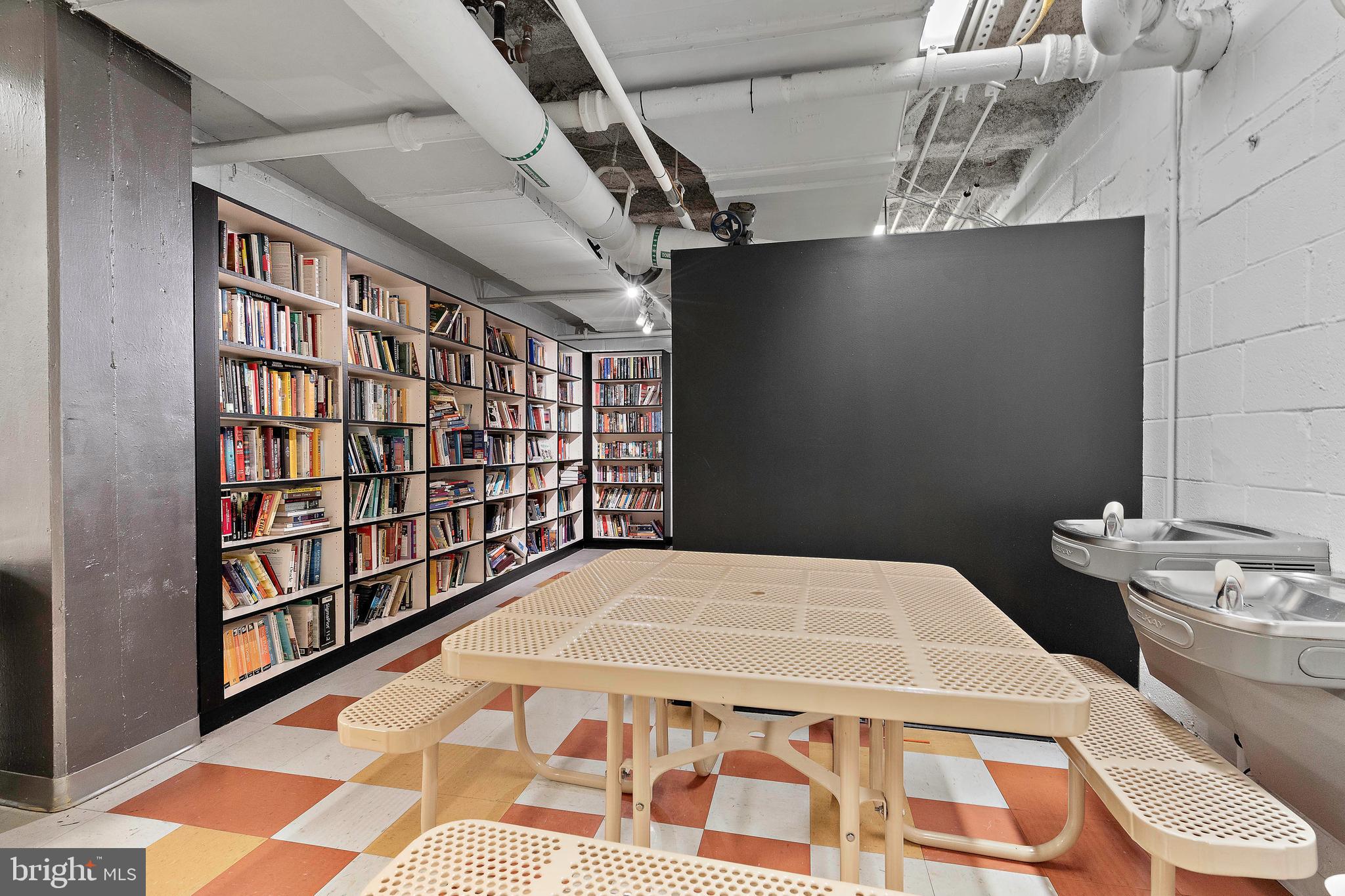 800 4th Street Southwest, Unit N801 Washington, DC 20024 - Photo 27 of 31 a bedroom with a bed and a book shelf