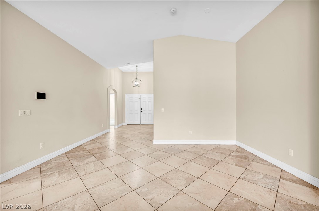 6405 North Raptor Court North Las Vegas, NV 89084 - Photo 17 of 66 Walk into this home with its elegant vaulted ceilings and classic tiled floors.