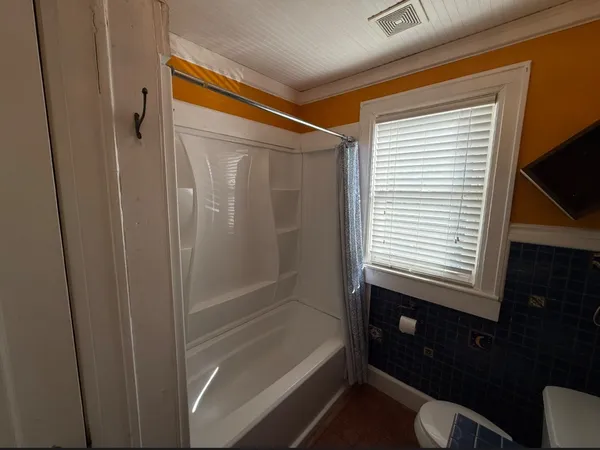 a bathroom with a bathtub and a shower