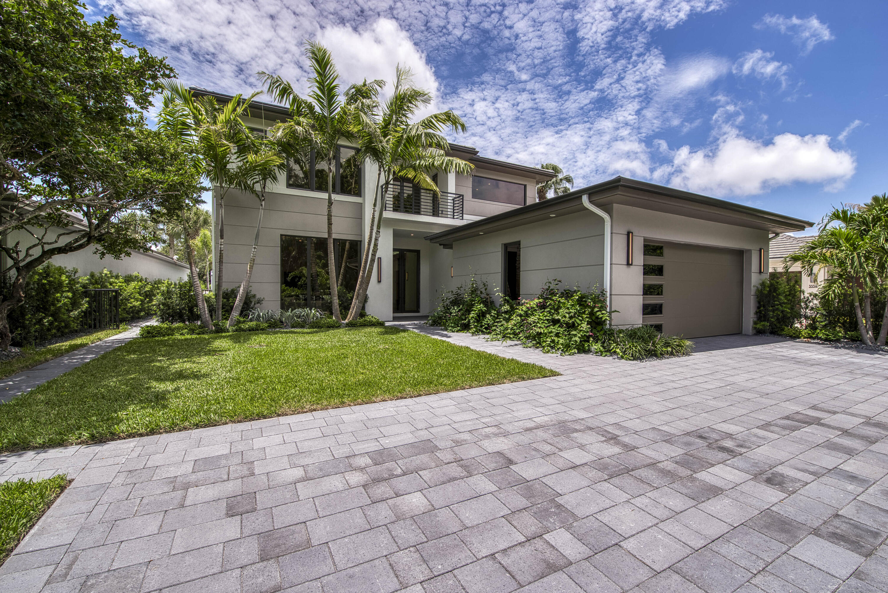 a front view of a house with a yard and a garage