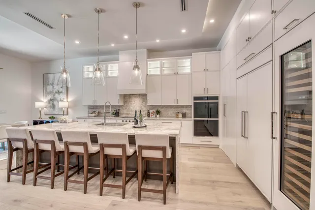 a kitchen with sink stove and cabinets
