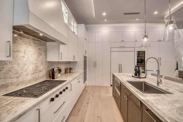 a kitchen with stainless steel appliances granite countertop a sink stove and refrigerator