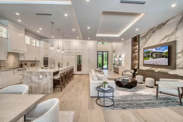a view of a dining room with furniture large windows and wooden floor