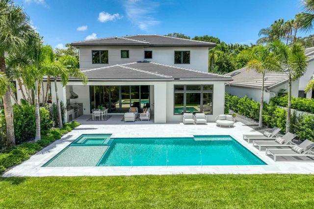a house view with swimming pool and garden view